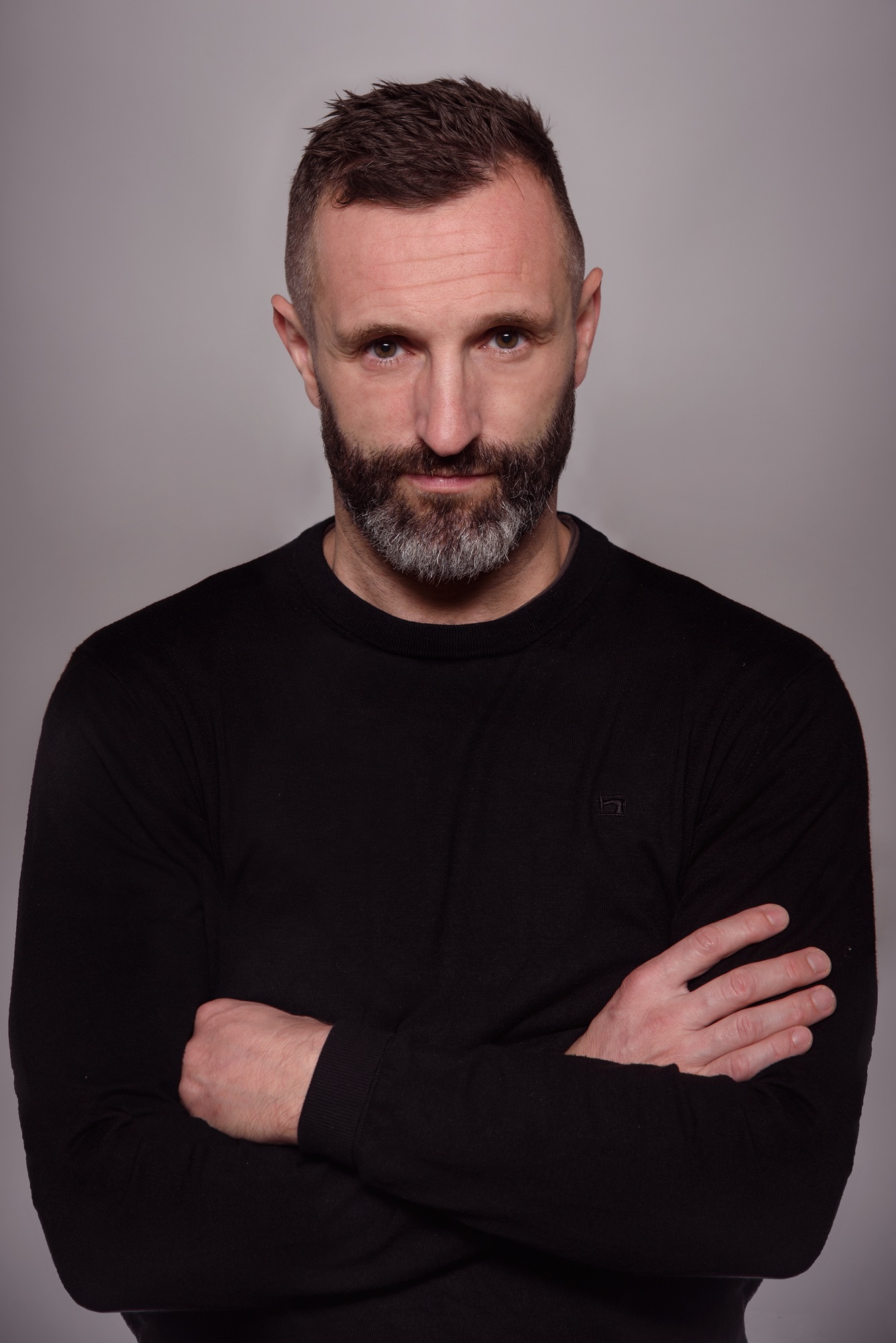 Wilson Meloncelli, studio portrait, arms crossed, black sweater